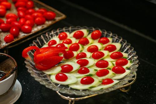 a cake with cherries on top of it on a table at Paradise Grand Center Hanoi Hotel in Hanoi