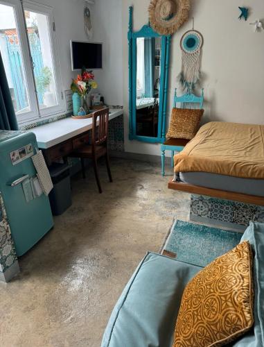 a bedroom with a desk and a bed and a mirror at CASA BOHO your happy place in Calheta in Calheta