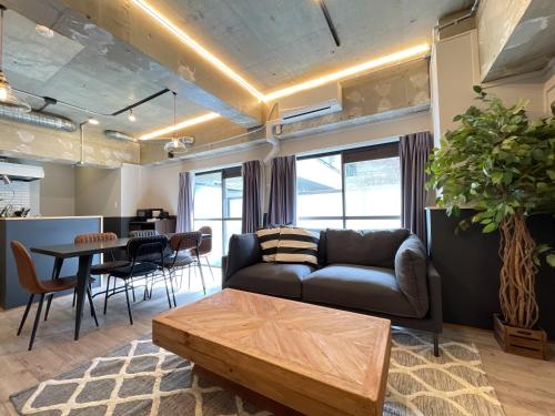 a living room with a couch and a table at Eims stay Oomori206 in Tokyo