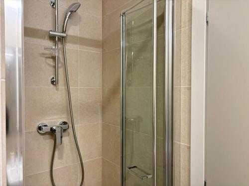 a shower stall with a glass door in a bathroom at H Pipera - 2BR - Lake View in Voluntari