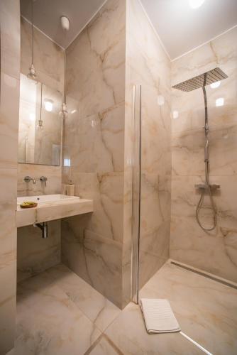 a bathroom with a shower and a sink at Saroko Apartment 2 in Ágios Rókkos