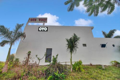 a white building with a one way sign on it at Hotel O Vinit Lodging in Nagpur