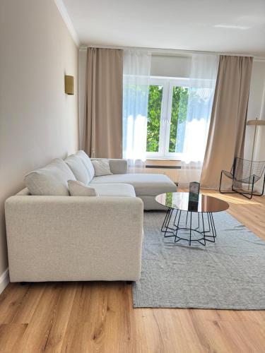 a living room with a couch and a table at Westerntor City Apartment in Paderborn