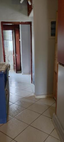an empty kitchen with a tile floor and a door at family in Kardítsa