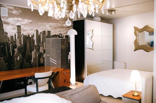 a bedroom with a white bed and a city mural at Central apartment in Gaono residence in Vilnius