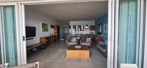 a living room with a couch and a table at Blue Ocean Suites & Apartments in Trou dʼ Eau Douce