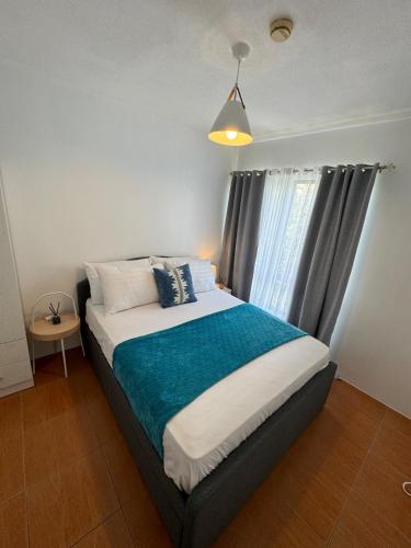 a bedroom with a large bed with a window at Modern Minimalist Luxe Retreat 2 Bedroom with parking in Manila