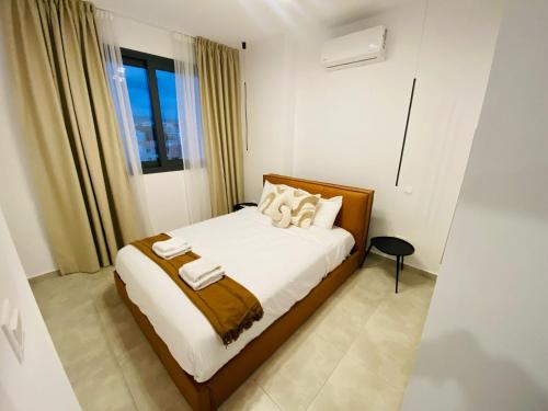 a bedroom with a bed with white sheets and pillows at Sea view Penthouse Universal Residences in Nea Paphos
