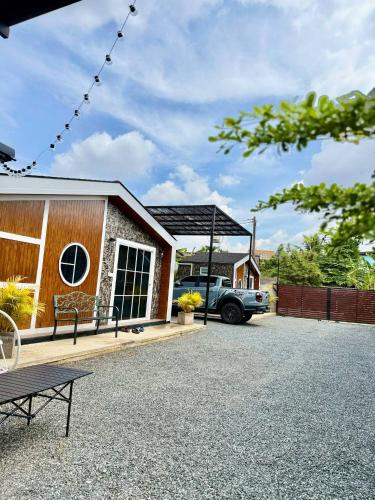 a house with a truck parked in front of it at Cina Home in Chiang Mai