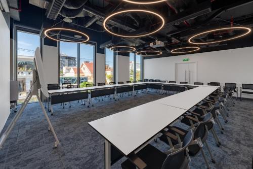 a conference room with a long table and chairs at Wink Hotel Tuy Hoa Beach - 24hrs Stay & Rooftop Pool Bar in Tuy Hoa