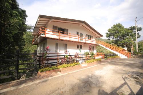 a house with a staircase in front of it at HOTEL LA SELVA Reserva in La Vega