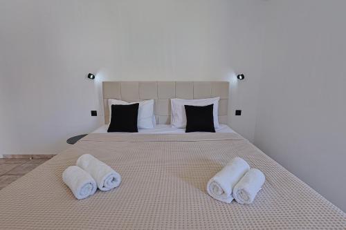 a bedroom with a bed with towels on it at AVENA Suites in Kato Gouves