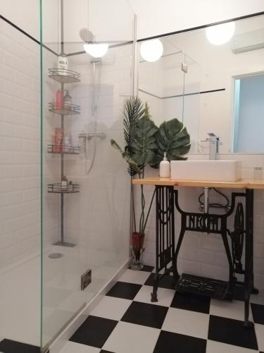a bathroom with a sink and a shower at A Casa da Vila in Alcochete