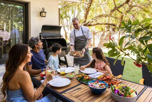 a group of people sitting around a table eating food at La Siesta Resort & Villas in Islamorada