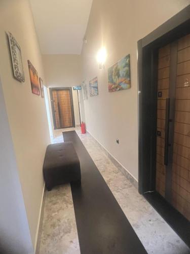 a hallway with a black ottoman in a room at Hayal Fener in Antalya