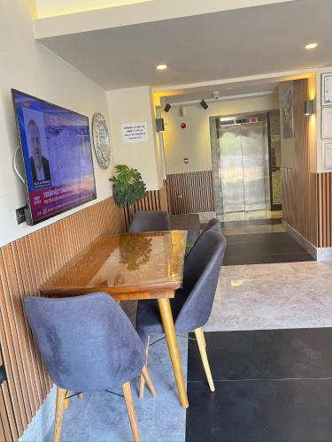 a dining room with a wooden table and chairs at Hayal Fener in Antalya