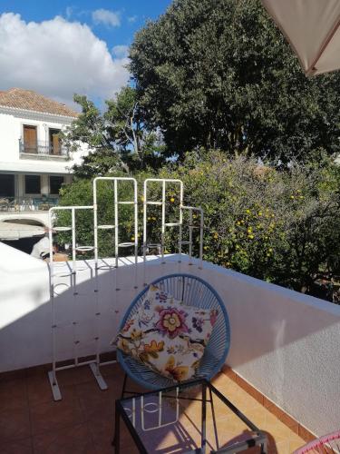 a chair with a pillow sitting on a balcony at A Casa da Vila in Alcochete