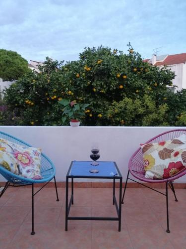 two chairs and a table on a patio at A Casa da Vila in Alcochete