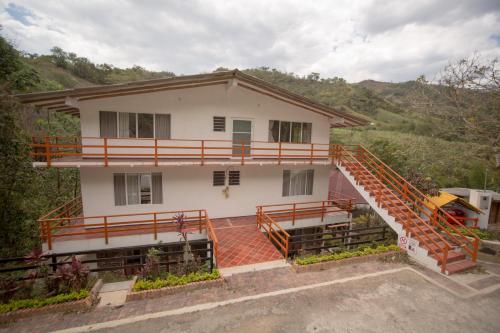 a house with a staircase in front of it at HOTEL LA SELVA Reserva in La Vega