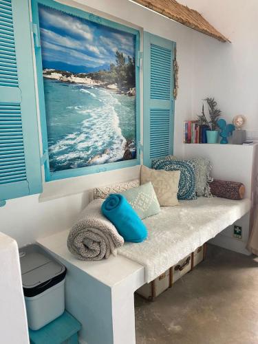 a bench in a room with a picture of the ocean at CASA BOHO your happy place in Calheta in Calheta