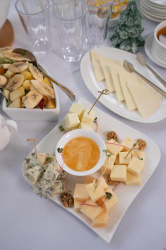 a table with plates of cheese and a bowl of dip at Hotel & Restaurant Emerald Borjomi in Borjomi