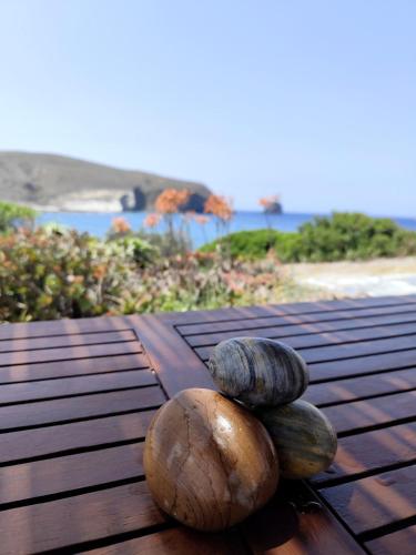 two coconuts sitting on top of a wooden table at Milos Pollonia Apartment in Mesochórion