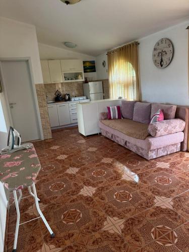 a living room with a couch and a kitchen at Sayohat Apartments in Dobra Voda