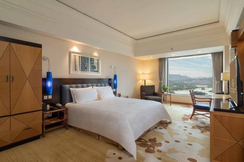 Postel nebo postele na pokoji v ubytování Huizhou Kande International Hotel
