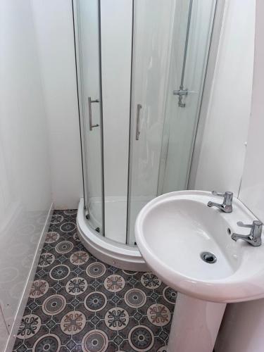 a bathroom with a sink and a shower at Springfield glamping in Marwood