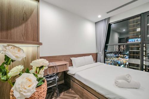 a hotel room with a bed and a large window at Shi House - 2BR Building BE2 Luxury, Park View in Long Bình