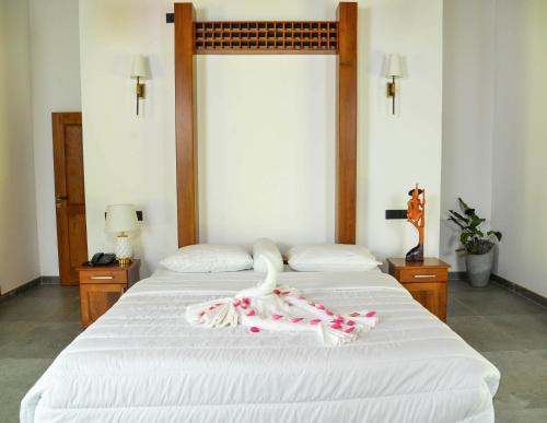 a bedroom with two beds with a swan on it at Villa Green Cocos in Katuwana