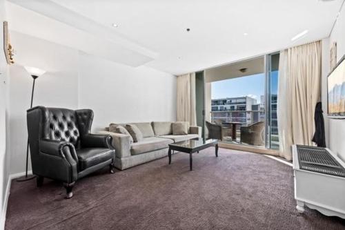 a living room with a couch and a chair at Luxury unit near to Sydney CBD and Airport 2b2b1p in Sydney