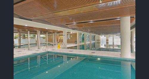 an indoor swimming pool with a large swimming pool at Luxury unit near to Sydney CBD and Airport 2b2b1p in Sydney
