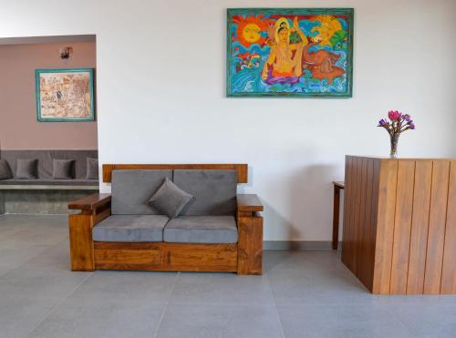 a chair in a room with a painting on the wall at Villa Green Cocos in Katuwana
