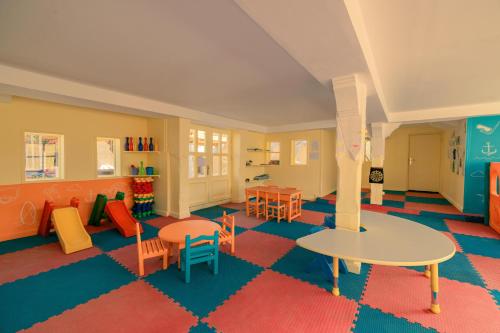a childrens play room with tables and chairs and a table at JAZ Sharm Dreams in Sharm El Sheikh