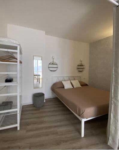 a bedroom with a bed and a book shelf at Residence Intur in Marciana Marina