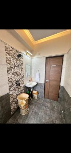 a bathroom with a toilet and a sink at Virat in Jāmb