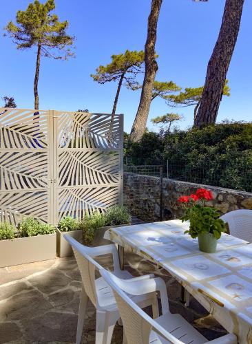 a table and chairs on a patio with trees at Residence Intur in Marciana Marina