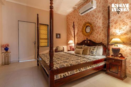 a bedroom with a canopy bed in a room at StayVista at Sitara with Jacuzzi & WiFi in Jaipur