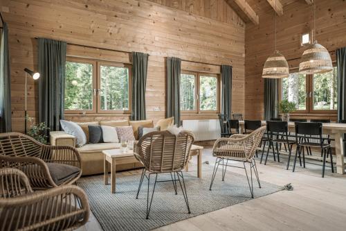 a living room with a couch and chairs and a table at Ramenai - Das Böhmerwaldlerdorf in Ulrichsberg