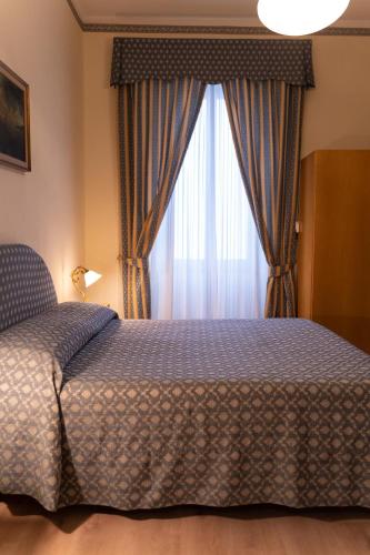 Una cama o camas en una habitación de Hotel Belvedere