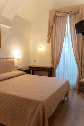 Una cama o camas en una habitación de Hotel Belvedere