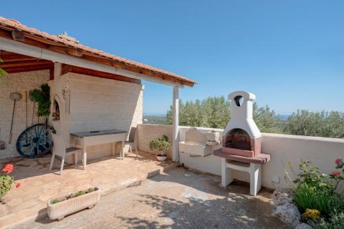 a patio with a pizza oven on a house at Casa Panoramica Greco in Monopoli
