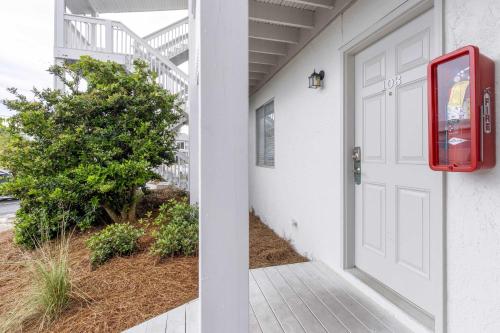 a white door of a house with a red mailbox at Coastal-Chic Condo Steps from the Sand in Destin