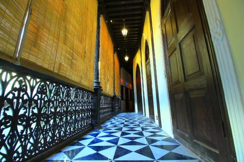 an empty hallway with a door and a tiled floor at Deewanji Ni Haveli in Ahmedabad