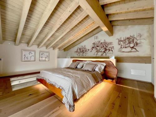 a bedroom with a large bed in a room with wooden ceilings at Bio Agriturismo Falezze in Illasi