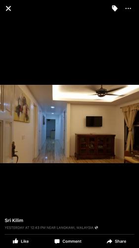a view of a living room with a television and a room at Sri Kilim Resthouse and Homestay Langkawi in Kilim