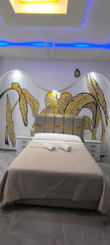 a bedroom with a bed with a painting on the wall at Casa Salma in Seville