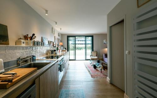 a kitchen with a sink and a counter top at Domaine de charme pres de Contis in Saint-Julien-en-Born