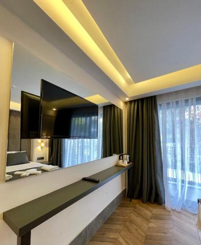 a hotel room with a large television on a wall at Brow City Kaş in Kas